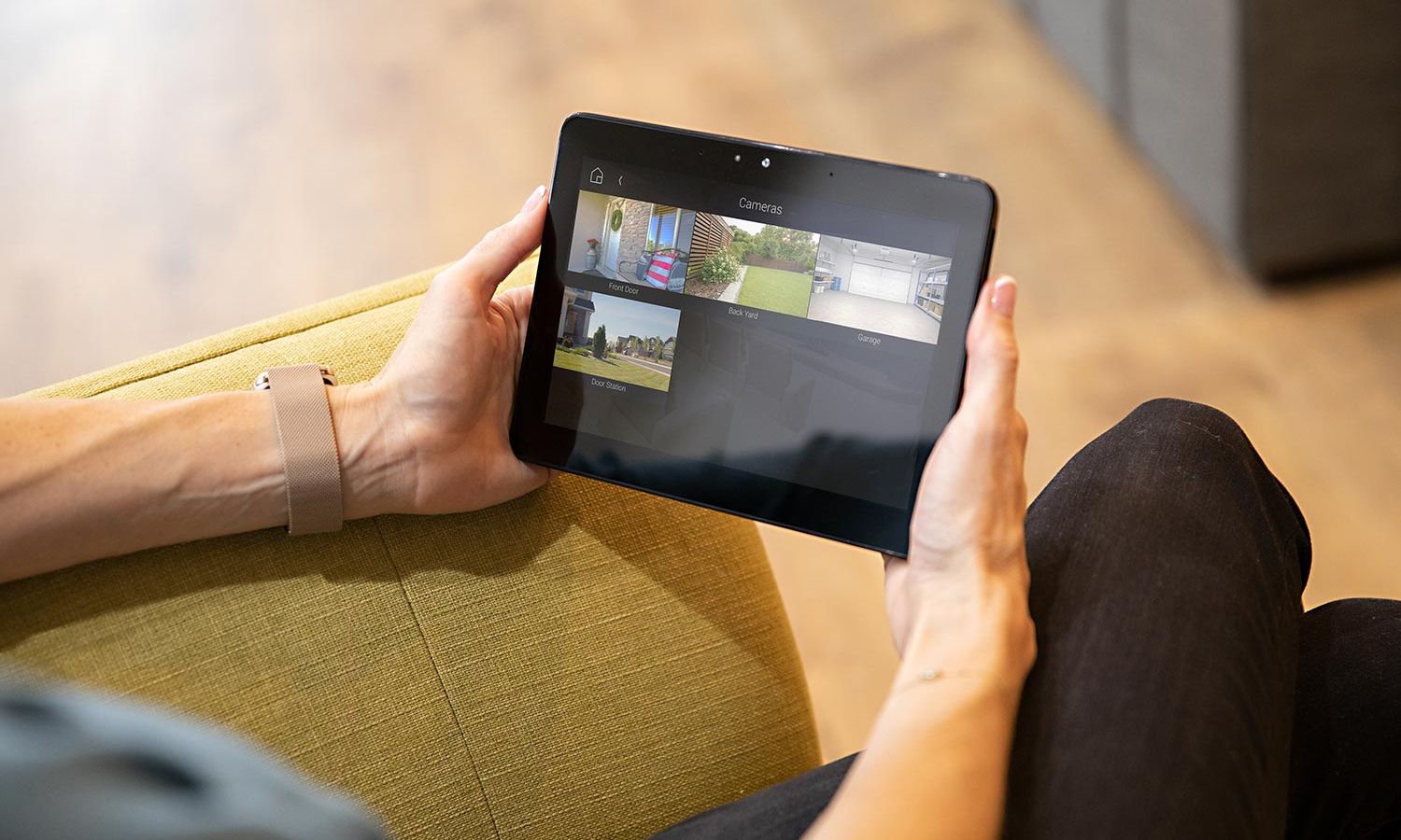 Woman holding an iPad with the Control4 Security Cameras interface