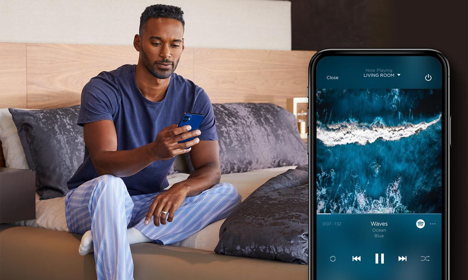Savant Audio control screen on a Phone in front of a man holding a phone