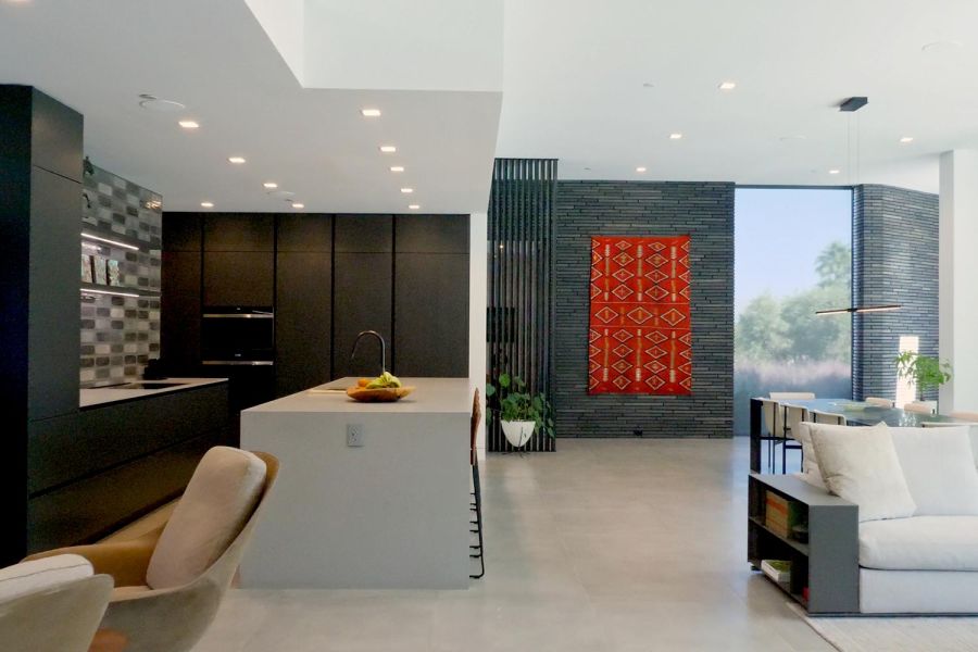 A spacious, well-lit kitchen and living area with contemporary design elements.